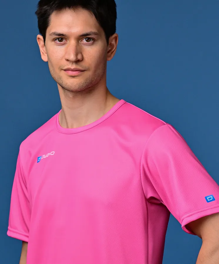 A man is wearing a bright pink sports shirt against a blue background.