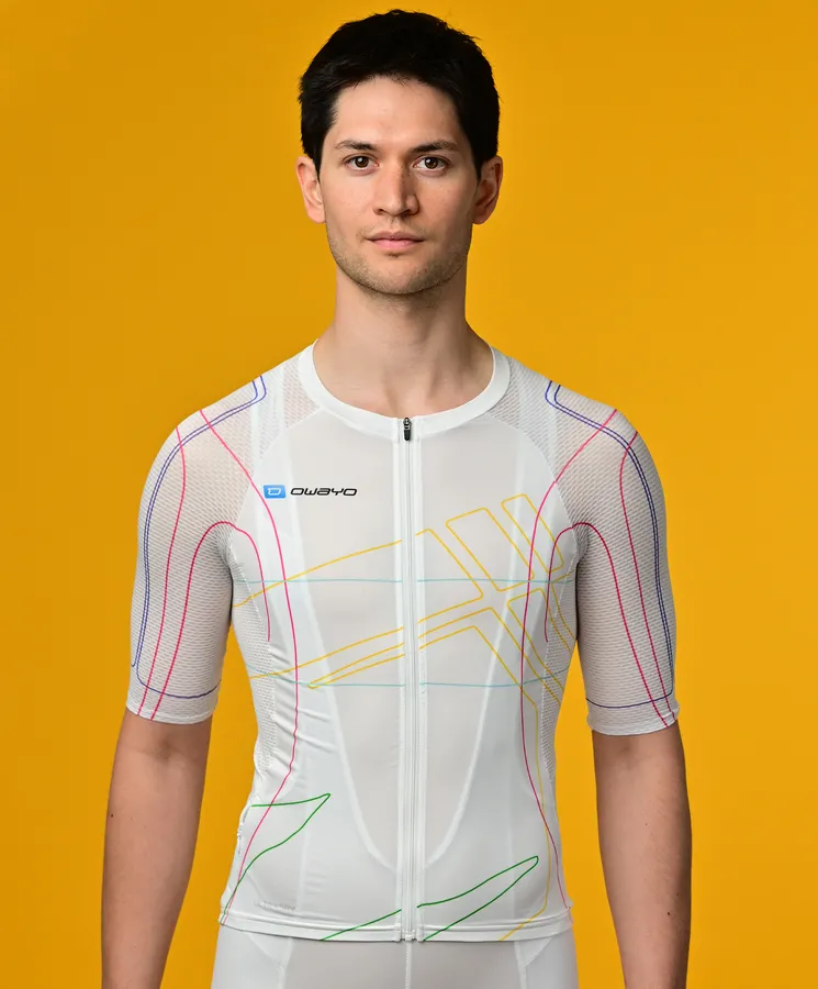 A man wears a white, short-sleeved, sport jersey with colorful lines from owayo against a yellow background.
