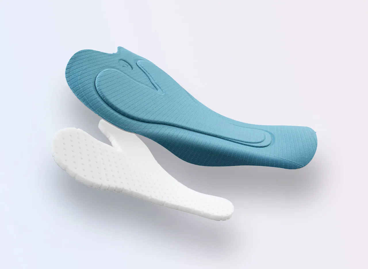 Two sports insoles in different colors, one light blue and one white, featuring textured surfaces.